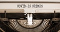 Text `Covid19 crimes` typed on retro typewriter. Business and post-pandemic covid-19 concept