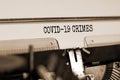 Text `Covid-19 crimes` typed on retro typewriter. Business and post-pandemic covid-19 concept