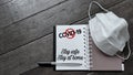 text covid-19 stay safe stay at home with stop sign written on notepad