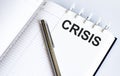 Text CRISIS on the short note texture background with pen Royalty Free Stock Photo