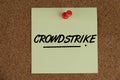 text of CROWDSTRIKE written on a yellow memo pad Royalty Free Stock Photo