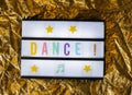 Text Dance on white illuminated board. Conceptual message for entertainment Royalty Free Stock Photo