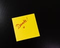 Text Danke on sticky note. Yellow sticky note on black background Royalty Free Stock Photo