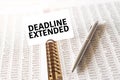 Text DEADLINE EXTENDED on paper card, pen, financial documentation on table Royalty Free Stock Photo