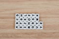 Text dice cube concept / Letter dices alphabet on wooden background. Block of alphabet studded on the floor