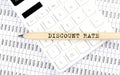 Text DISCOUNT RATE on wooden pencil on calculator with chart Royalty Free Stock Photo