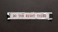 The text Do the Right Thing appearing behind torn brown paper Royalty Free Stock Photo