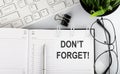 Text DON`T FORGET on calendar planner with keyboard,glasses and pen on white background Royalty Free Stock Photo