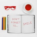 Text dont forget to smile written in a notepad