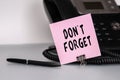 The text DonT Forget written on a pink sticky note to remind you an important event. Closeup of a personal agenda Royalty Free Stock Photo