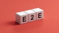 text E2E is written on wooden cubes standing in a row. around the blocks with letters. can be used for business Royalty Free Stock Photo