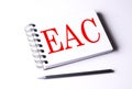 Text EAC on notebook on the white background Royalty Free Stock Photo