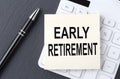 Text EARLY RETIREMENT on the sticker on the calculator, business concept Royalty Free Stock Photo
