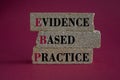 Text EBP Evidence-based practice concept on brick blocks. Beautiful red background.