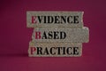 Text EBP Evidence-based practice concept on brick blocks. Beautiful red background. Royalty Free Stock Photo