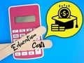 Text Education Costs at ice cream stick, calculator and icon. Education and finance concept. Royalty Free Stock Photo