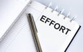 Text EFFORT on the short note texture background with pen Royalty Free Stock Photo