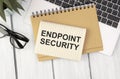 ENDPOINT SECURITY on brown paper notepad in businessman hands in office. Business concept Royalty Free Stock Photo