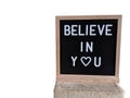 Text in english spelling Believe in You on a black felt sign board in a wooden frame Royalty Free Stock Photo