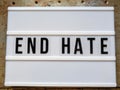 Text in english spelling `End Hate` on a lightbox against industrial background Royalty Free Stock Photo