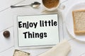 Text enjoy little things in a tablet Royalty Free Stock Photo