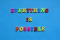text everything is possible from plastic colored letters on blue paper background. Royalty Free Stock Photo