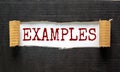 The text `examples` appearing behind torn black paper. Business concept