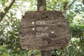 Text exit, shop and toilet on a wooden board in a rainforest jungle of tropical Bali island, Indonesia. Exit, shop and toilet