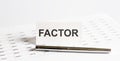 Text FACTOR on stickers,pen on the background of documents. Financial bookkeeping, Accounting Concept. Top view