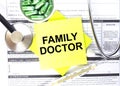 Text Family Doctor in a notebook on medical forms with a phonendoscope and green pills Royalty Free Stock Photo