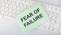 Text FEAR OF FAILURE on envelope on keyboard on the white background