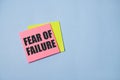 text fear of failure, on pink stikers on blue background