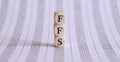 Text FFS on a wooden cube blocks on chart Royalty Free Stock Photo