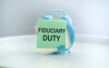 Text Fiduciary Duty text on sticky on Alarm Clock, Business concept.