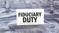 Text fiduciary duty on a white paper stuck out from jeans pocket. Business concept