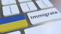 IMMIGRATE text and flag of Ukraine on the buttons on the computer keyboard. Conceptual 3D rendering