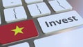 INVEST text and flag of Vietnam on the buttons on the computer keyboard. Business related conceptual 3D rendering Royalty Free Stock Photo