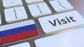 VISIT text and flag of Russia on the buttons on the computer keyboard. Conceptual 3D rendering