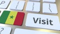 VISIT text and flag of Senegal on the buttons on the computer keyboard. Conceptual 3D rendering