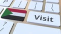 VISIT text and flag of Sudan on the buttons on the computer keyboard. Conceptual 3D rendering