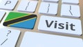 VISIT text and flag of Tanzania on the buttons on the computer keyboard. Conceptual 3D rendering