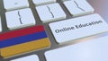 Online Education text and flag of Armenia on the buttons on the computer keyboard. Modern professional training related