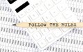 Text FOLLOW THE RULES on the wooden pencil on the calculator with chart Royalty Free Stock Photo