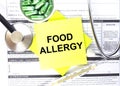 Text Food Allergy in a notebook on medical forms with a phonendoscope and green pills Royalty Free Stock Photo
