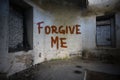 Text forgive me on the dirty old wall in an abandoned house Royalty Free Stock Photo