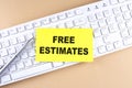 Text FREE ESTIMATES text on a sticky on keyboard, business concept