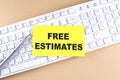 Text FREE ESTIMATES text on a sticky on keyboard, business concept