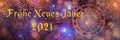 Text `Frohes Neues Jahr 2021` means Happy New Year 2021 in German. Blurred background of decorated Christmas tree with big golden 