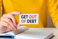 Text get out of debt written on a white paper card in woman hand, concept Royalty Free Stock Photo