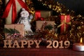 text happy 2019 in the foreground and new year decorations on a brown wooden background. new Year. Christmas. holidays Royalty Free Stock Photo